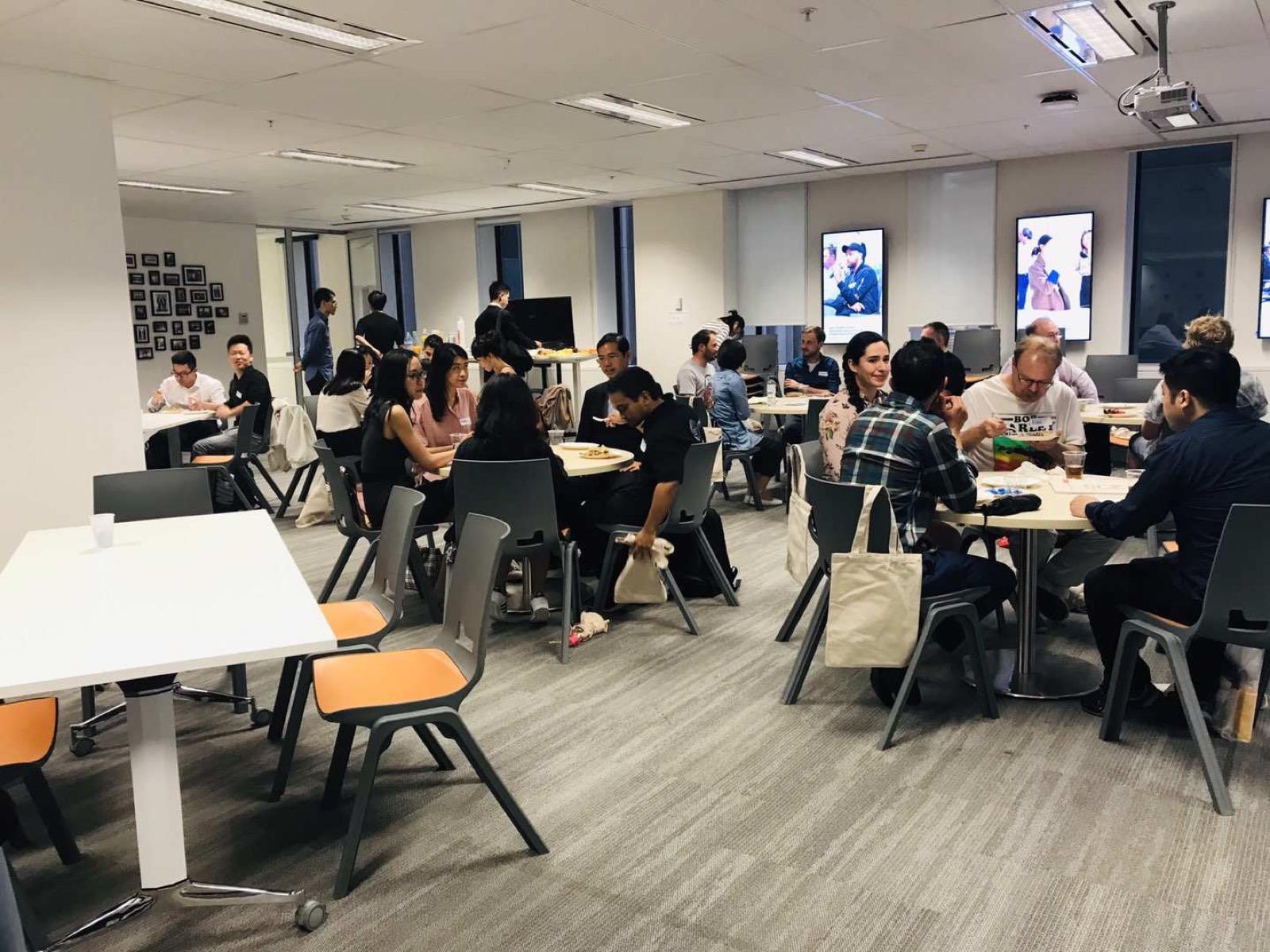 A busy community social evening with many people at tables at the NSFC Chatswood venue