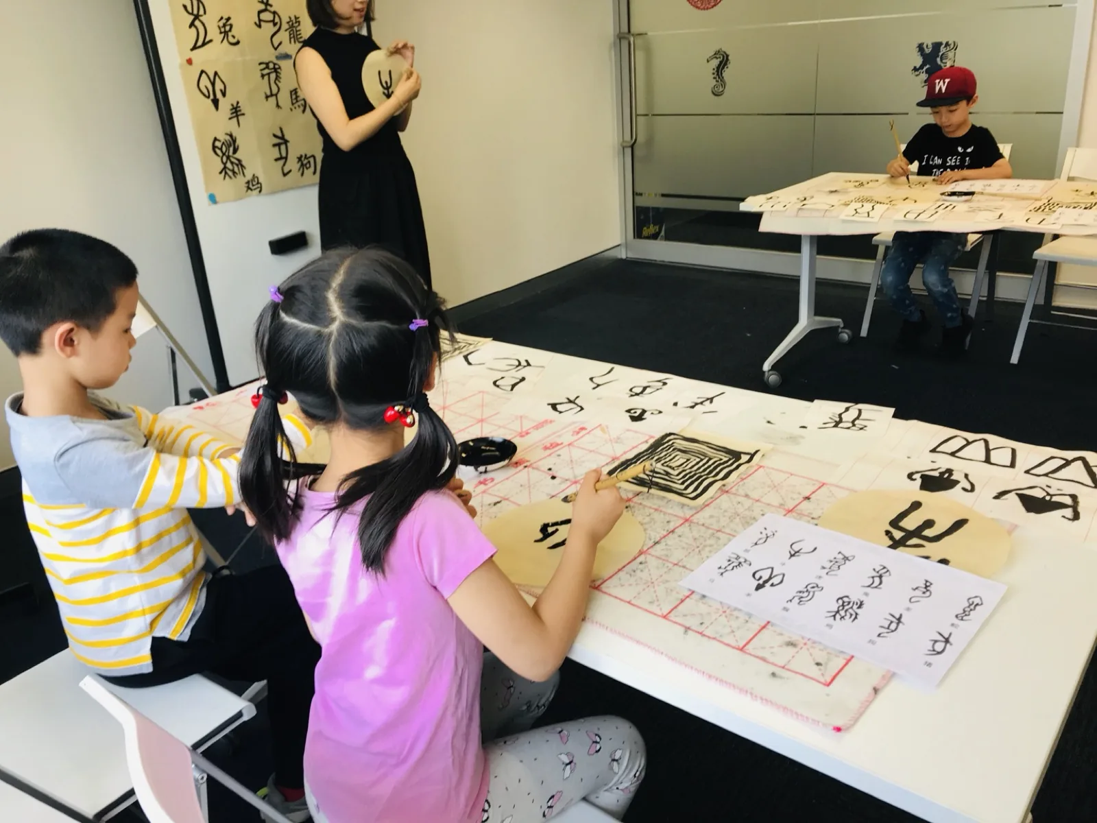 Children practising Chinese calligraphy at a class in the NSFC Chatswood venue